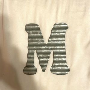 tin “M” sign